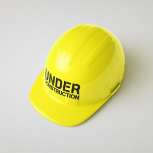Yellow hard hat with words "Under Construction" on it