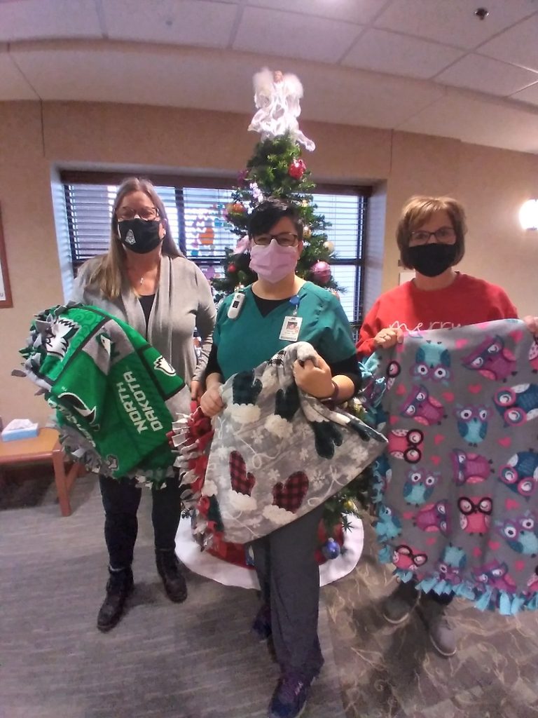 Margie Evers and Lori Morken from One Stop deliver blankets to the Cancer Center.