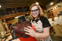 Emily Taylor shows off her "lace" collar that she made out of a bicycle tire inner tube. Taylor, a UND Theatre Arts master's degree student, used her "trash to treasure" style to win a prestigious scholarship to a stagecraft school in Las Vegas. Photo by Jackie Lorentz.