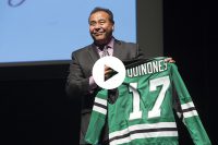 John Quinones proudly holds a UND hockys jersey given to him by  Delta Gamma after his speak at the Chester Fritz Auditorim Monday night.