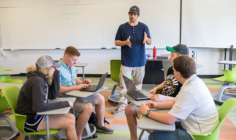 Math Graduate Teaching Assistant Jarod Olson leads his summer pre-calculus focus group through a real-world math problem. Olson helped develop a new new curriculum that will be integrated when UND’s Math Active Learning Lab (MALL) opens in O’Kelly Hall this fall. Photo by Tyler Ingham.