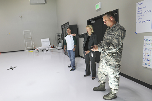 Colonel Benjamin Spencer (right) from the Grand Forks Air Force Base flies a small UAS in the UAS Flight Testing Lab in Robin Hall as Associate Dean of UND Aerospace Beth Bjerke (middle) and Assistant Professor of Aviation Philip Brandt (left) watch. Photo by Jackie Lorentz.