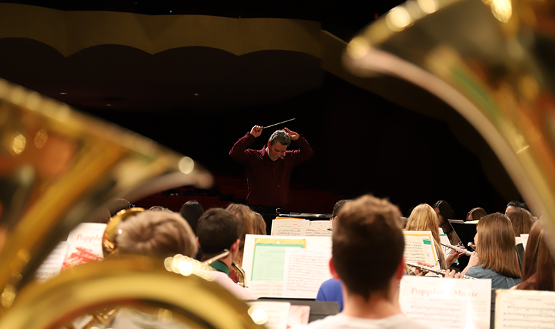 James Popejoy, conductor the festival’s Honor Band and director of bands at UND, rehearses with his 125-piece group on Saturday. The rehearsals are a time of musical growth for the students participating — something he regards as, “quite electric!” Photo by Connor Murphy/UND Today.