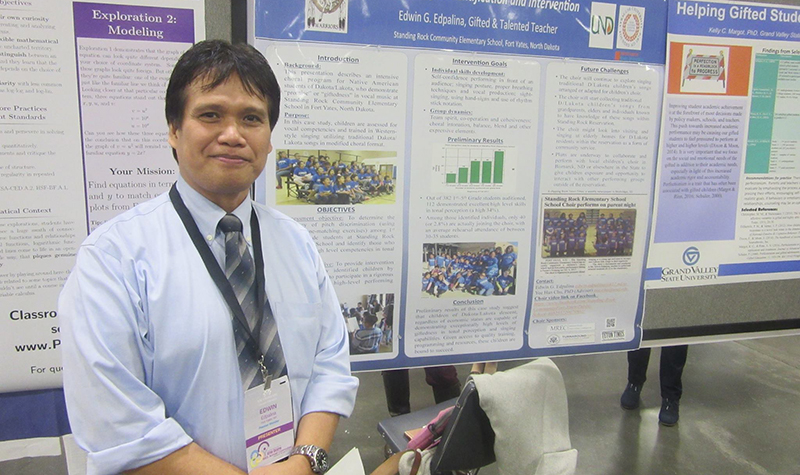 Edwin Edpalina stands next to his poster presentation at the NAGC’s 64th Annual Convention in Charlottesville, NC. In auditioning the entire elementary school, he discovered about 20 percent of children had fully developed tonal perception. Image courtesy of Edwin Edpalina.