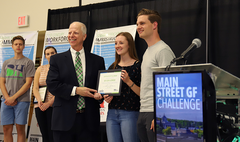 UND Provost Tom DiLorenzo (left) and Evolve Grand Forks’ Executive Director Collin Hanson (right) presented certificates to the challenge winners in attendance of June 13’s Main Street GF Challenge launch. The ceremony recognized the student winners and their ideas for enhancing the community. Photo by Connor Murphy/UND Today.