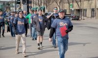 Alex Turner (front) leads brothers of the Alpha Sigma Phi fraternity to their downtown work site during Saturday's Big Event. Students and volunteers went to places across the community to help with spring cleanup. Photo by Connor Murphy/UND Today.
