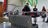 Paul Snyder, director of the UND Aerospace UAS Program, shows the school's UAS capabilities to a a group of visitors. Snyder is a member of the ASTM International committee that developed industry standards for UAS training and operations. Photo by Patrick C. Miller/UND Today.