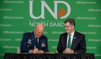 University of North Dakota President Andy Armacost and United States Space Force General John W Raymond sign a Memorandum of Understanding on Monday, Aug 9, 2021 in Robin Hall in Grand Forks, N.D.