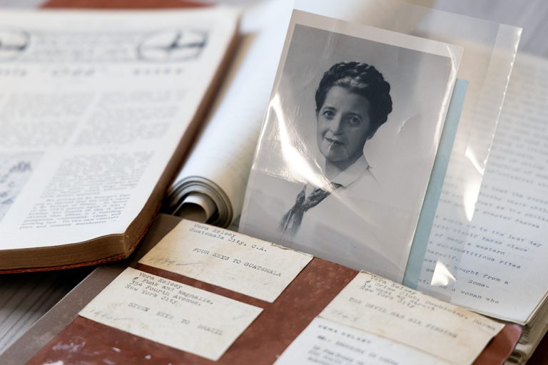 black and white photo of subject with old papers