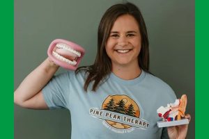 women holds props of mouth and ear