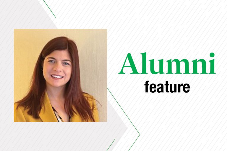 Jamie Holmgen in a yellow blazer posing for professional photo