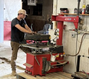 an employee using the machine for tires