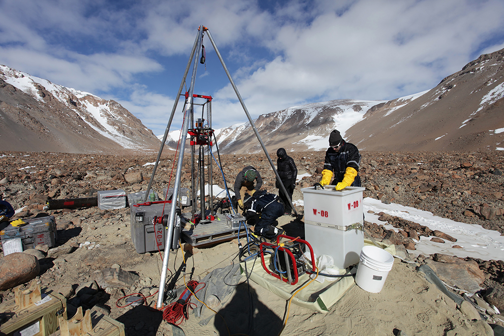 Researchers working on equipment in Antarctica