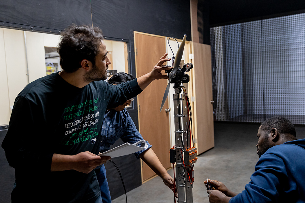 Students work on UAS device in experimental wind tunnel at UND