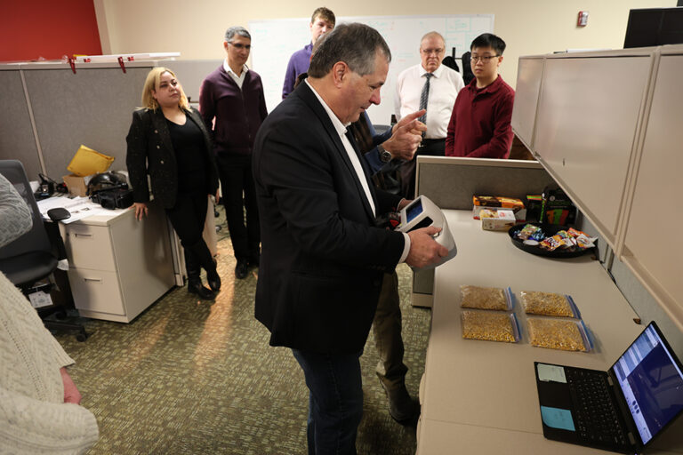 North Dakota Agriculture Commissioner Doug Goehring tests a contamination and sanitation inspection system at the UND Center For Innovation