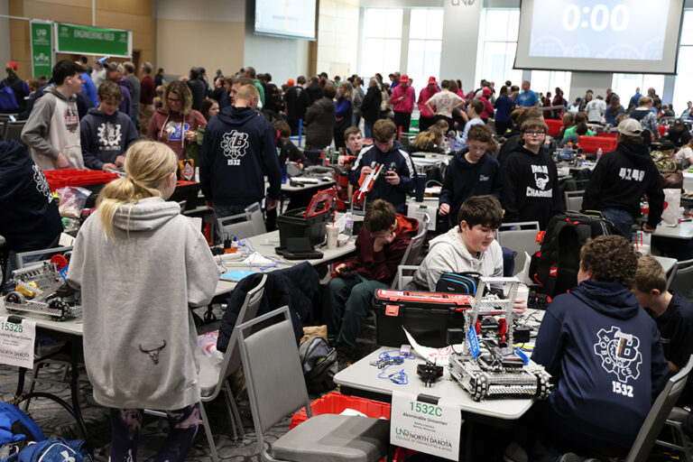 A ballroom full of high school students competing in a robotics competition