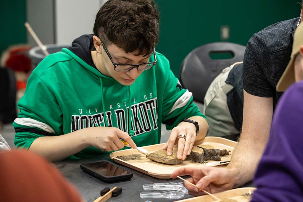 Student participates in fossil preparation session