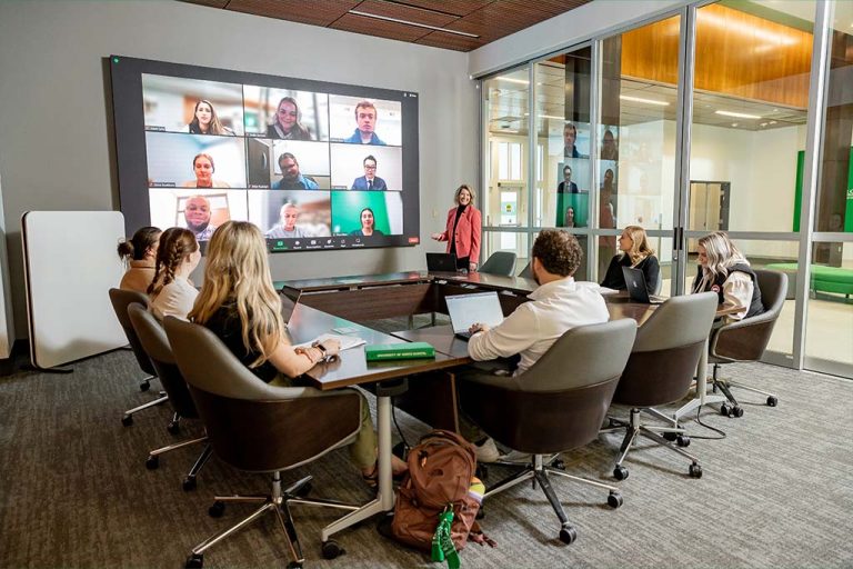 Faculty and students in a meeting room