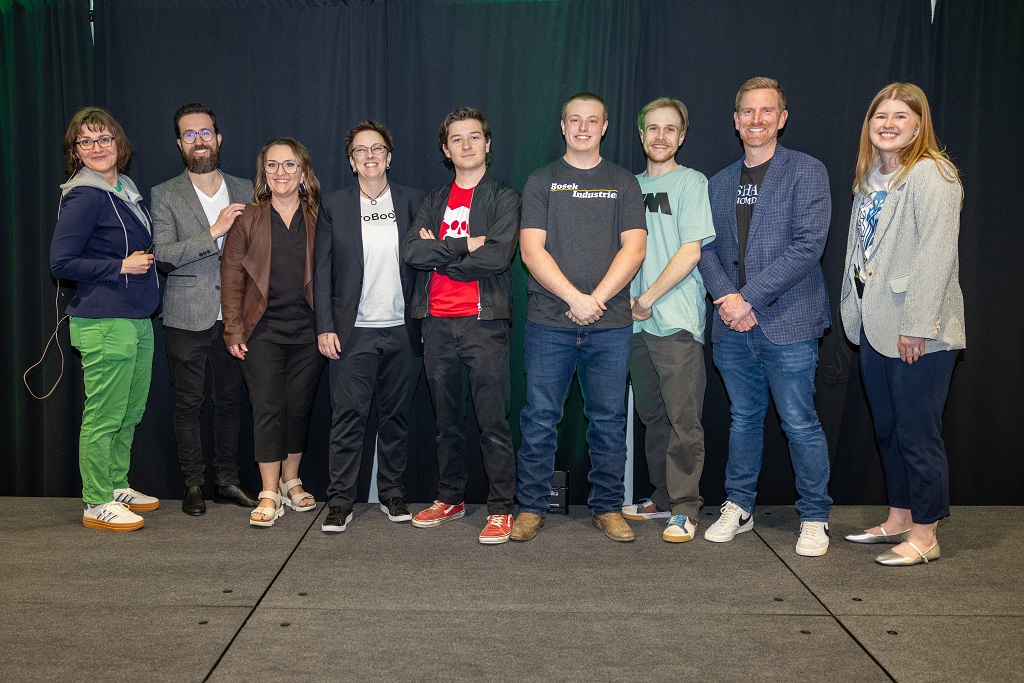 A group of people stand in a line for a photo