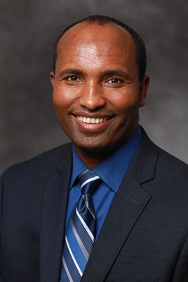 A professional headshot of Daba Gedafa.