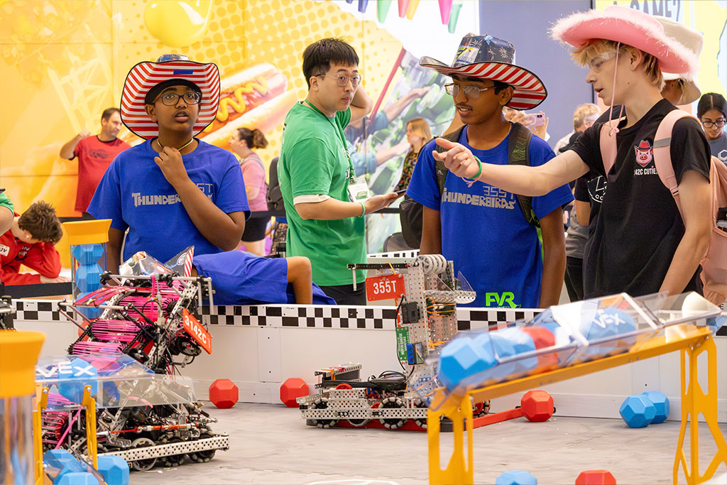 Students dressed colorfully in costumes and matching team uniforms work together to compete against other teams.