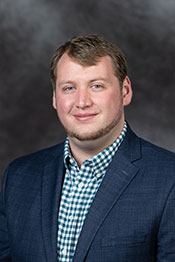 A professional headshot of Nolan Theaker