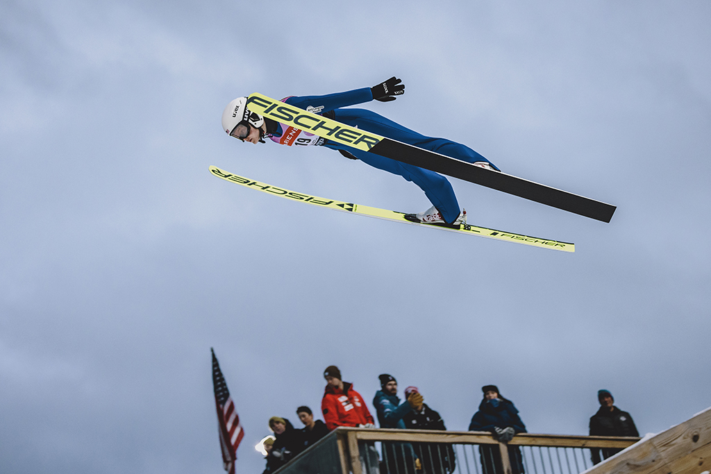 A ski jumper flies mid-air during a jump.