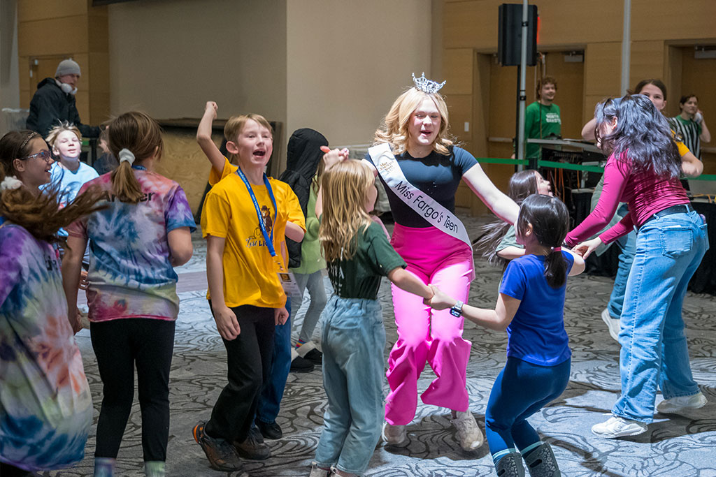 Children dance and play during a robotics competition at the University of North Dakota.