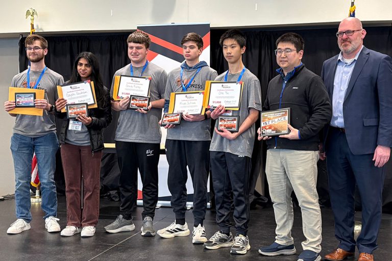 A line-up of students holding certificates alongside mentors.