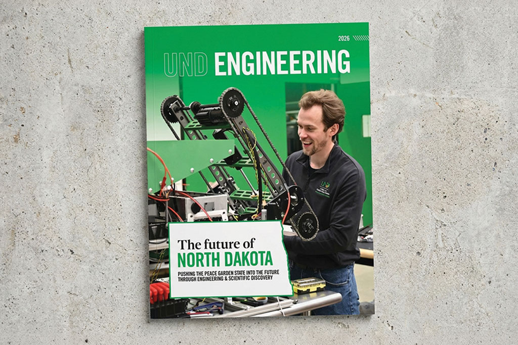 A cover of the UND Engineering 2026 Magazine. The featured story reads: "The Future of North Dakota." On the cover, a student smiles as he works on a lunar mining robot.