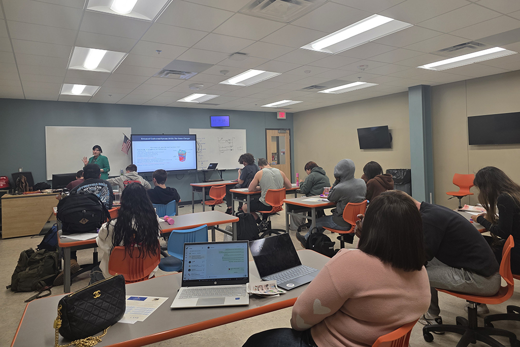 Students sit inside of a classroom.