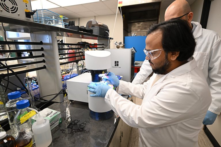 A student and a faculty member work alongside each other in an environmental engineering lab at the University of North Dakota.