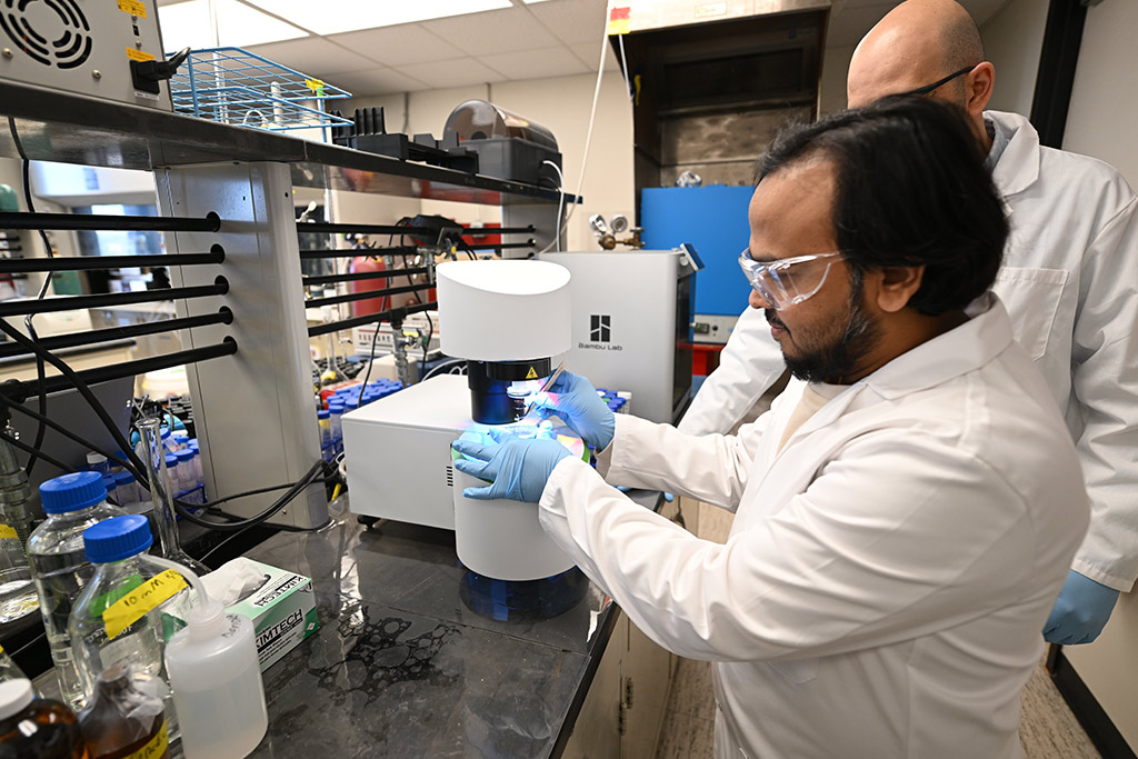 A student and a faculty member work alongside each other in an environmental engineering lab at the University of North Dakota.