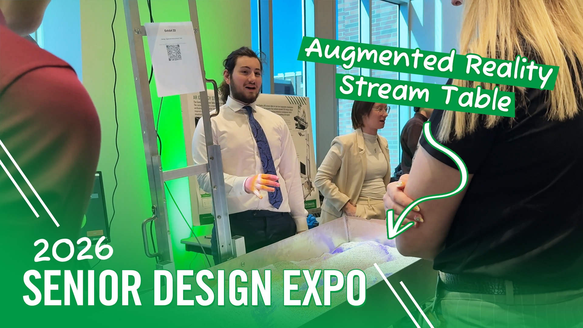 A video thumbnail that reads: "2026 Senior Design Expo | Augmented Reality Stream Table". The thumbnail features a student gesturing to a prototype as he stands next to a research poster.