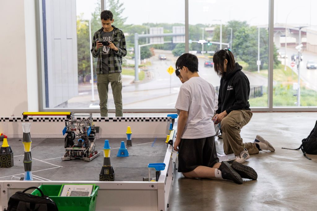 A group of students work together on a practice arena for a robotics competition hosted by the University of North Dakota at the Mall of America.