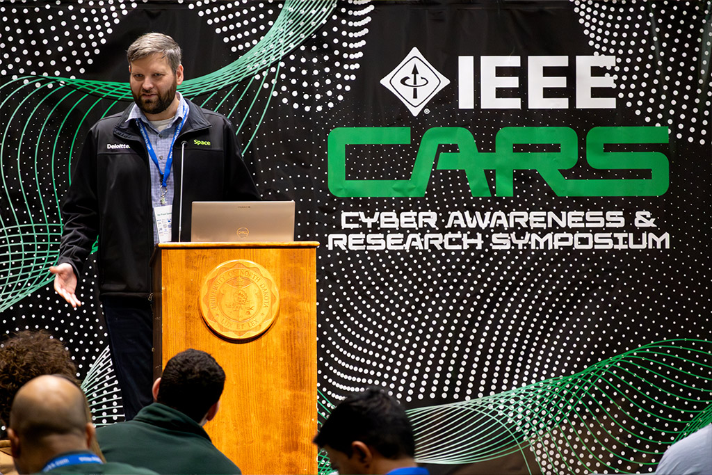 A man stands at a podium as he gives a lecture.