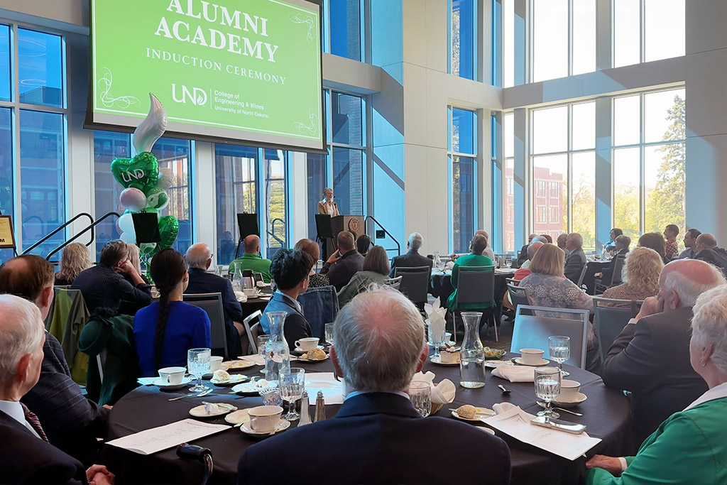 A room full of guests watch a ceremony held at the University of North Dakota.