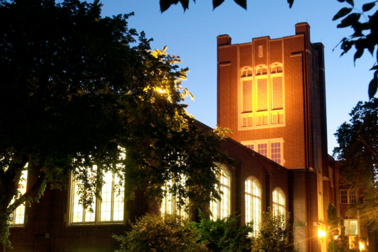 CFL building lit up at dusk
