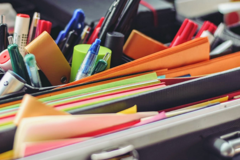 Organization kit with pens, highlighters, papers, and other office materials