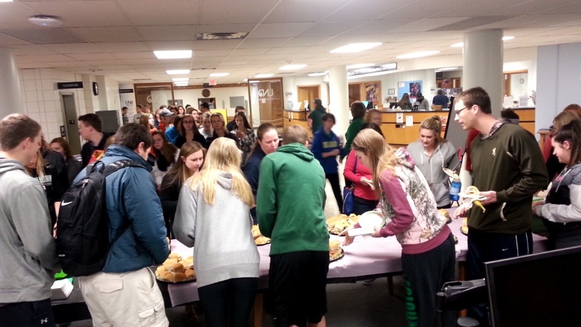 Students line up for food during the Press Pause event.