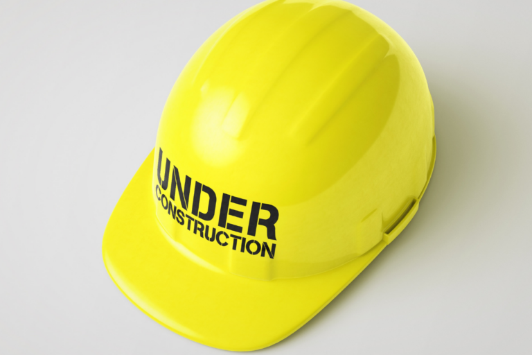 Yellow hard hat with words "Under Construction" on it