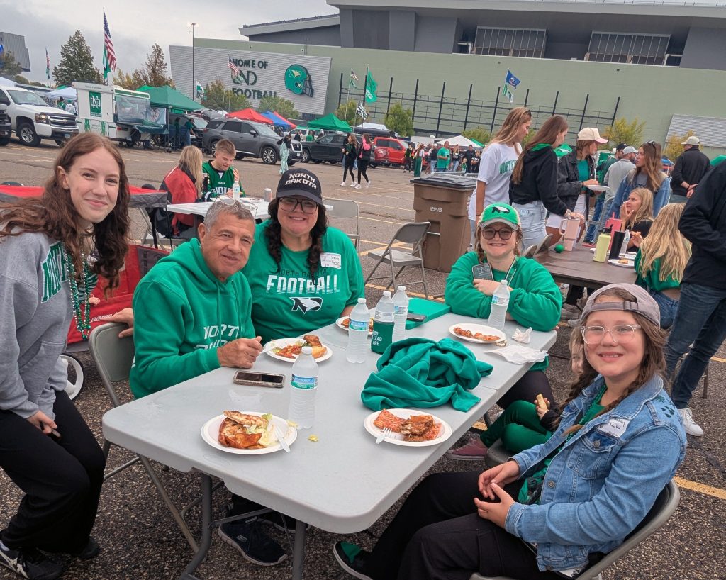 Guests enjoy food sitting at a table
