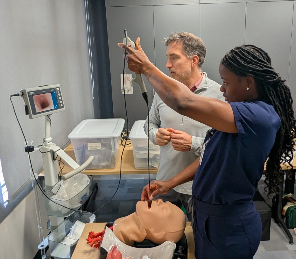 James Sperle guides a student through a procedure