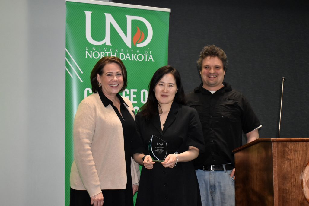 Dr. June Yung Kim receiving her award