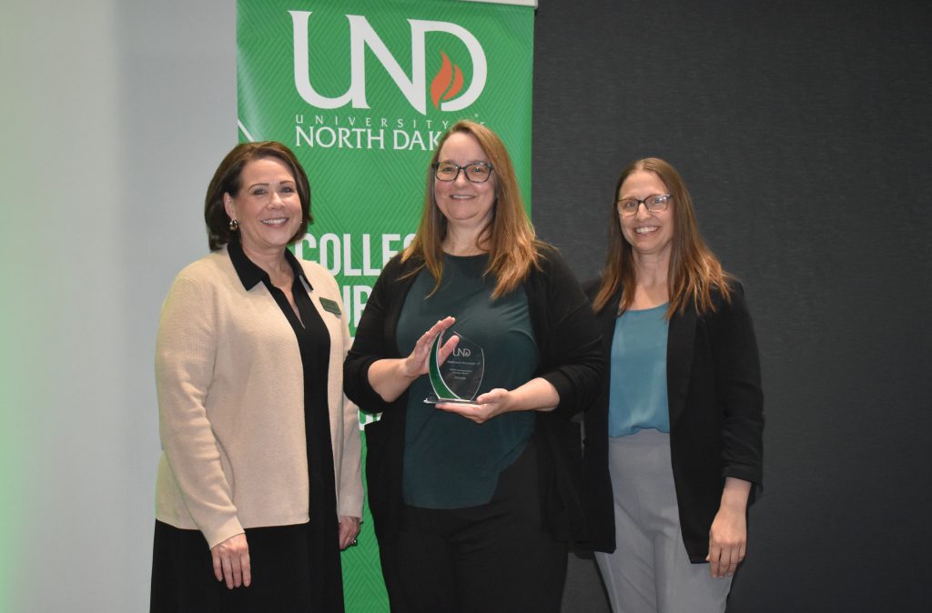 Stephanie Homstad holds an award