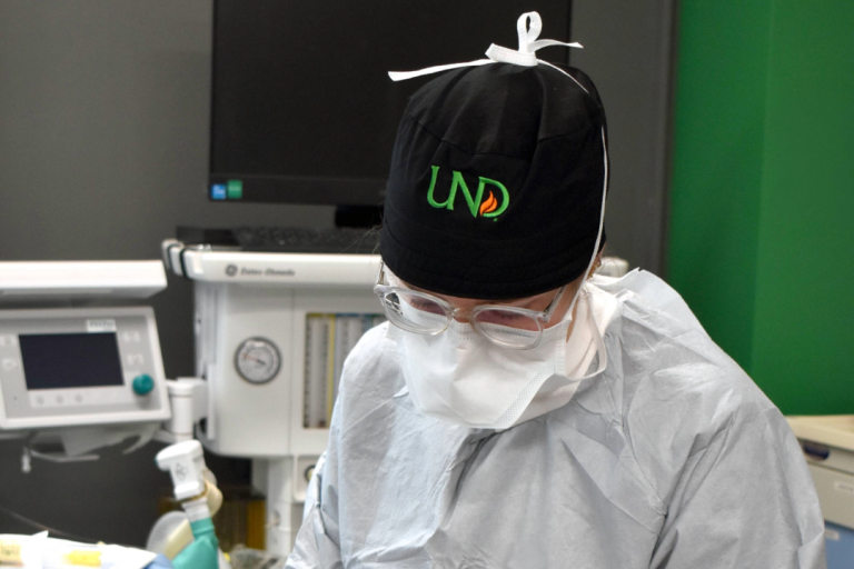 A CRNA student in a UND strub hat