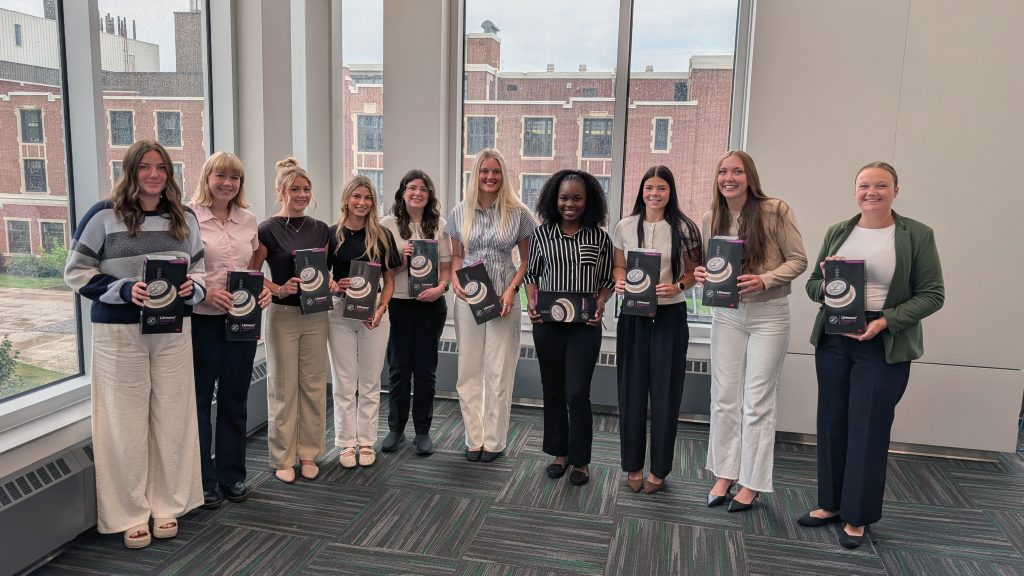 Ten students pose for a group photo holding stethohscopes they received at the fall 2026 Lamp of Knowledge Ceremony as Scrubs & Scopes recipients.