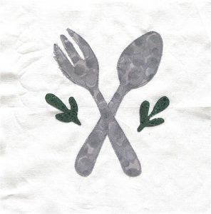 A quilt graphic showing a crossed set of fork and spoon