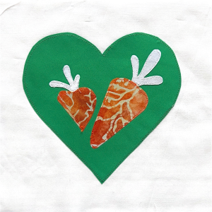 A quilt graphic of vegetables on a green heart