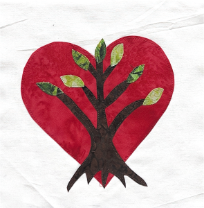 A quilt graphic with a red heart behind an image of tree